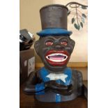 A cast iron man in a top hat pattern moneybox