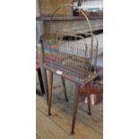 An old brass and mahogany magazine stand, set on later tapered legs