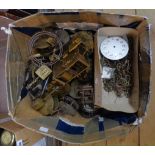 A box containing French and other small clock movements and other clock spares