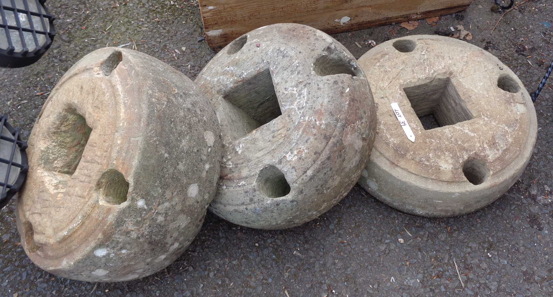 Three sandstone drive wheels