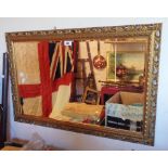 A gilt framed bevelled oblong wall mirror with decorative pierced border