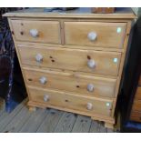 A 32" modern waxed pine chest of two short and three long drawers, set on bracket feet