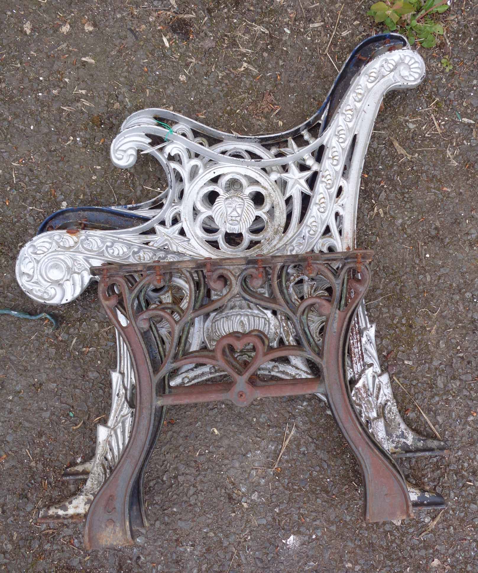 A pair of cast iron bench ends and table brackets