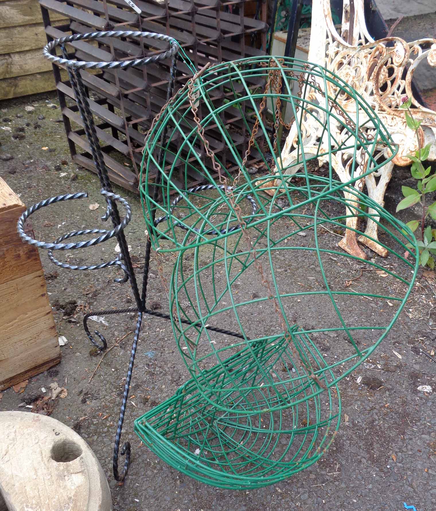 A wrought iron plant stand - sold with three hanging baskets