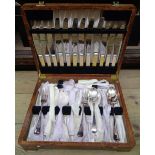 A 1930's polished oak canteen containing silver plated cutlery