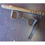 A truncheon and pair of Hiatt handcuffs (no key)