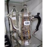 A silver plated coffee pot and hot water jug of tall baluster form with hinged lids, wooden