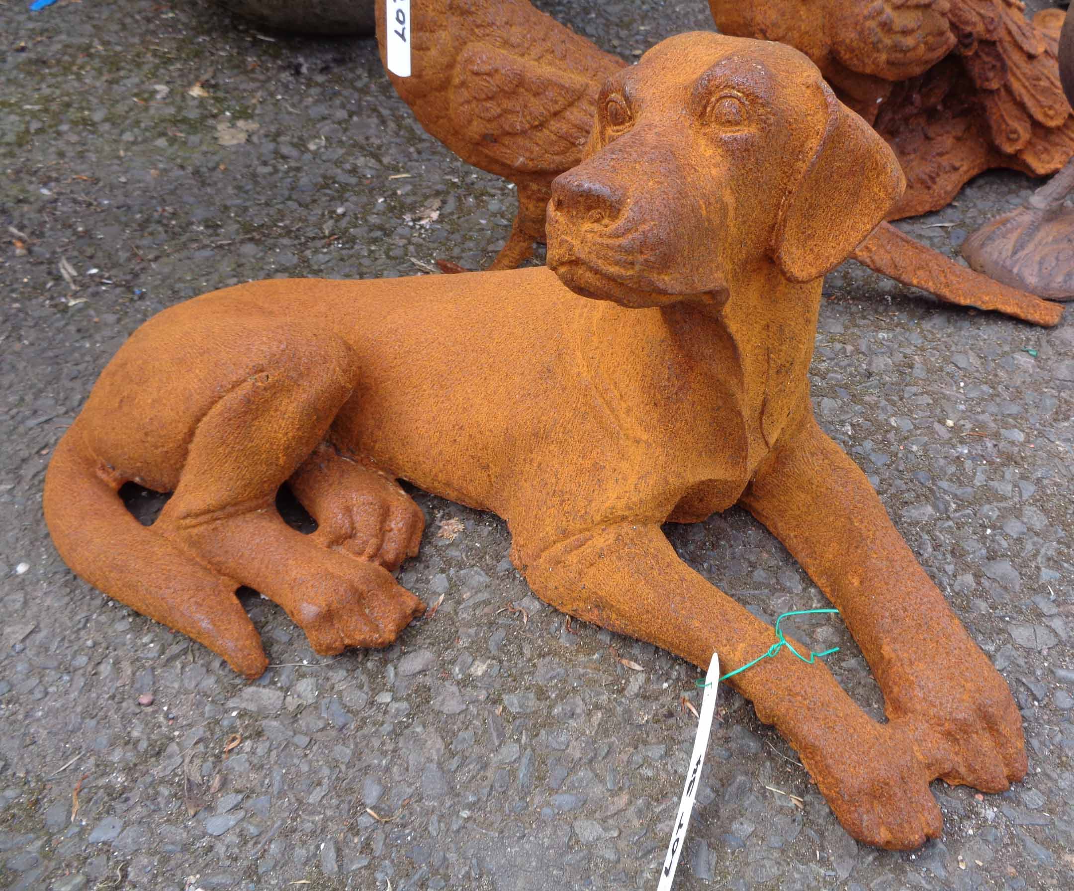 A cast iron lying dog with rusted finish