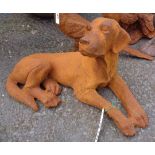 A cast iron lying dog with rusted finish