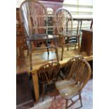 A set of four 20th Century polished wood framed wheel back kitchen chairs - sold with a similar
