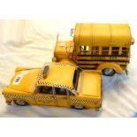 A modern tinplate model of an American school bus and a similar model of a yellow New York taxi