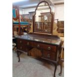 A 3' 8" 20th Century walnut knee-hole dressing table with Queen Anne style swing mirror over four