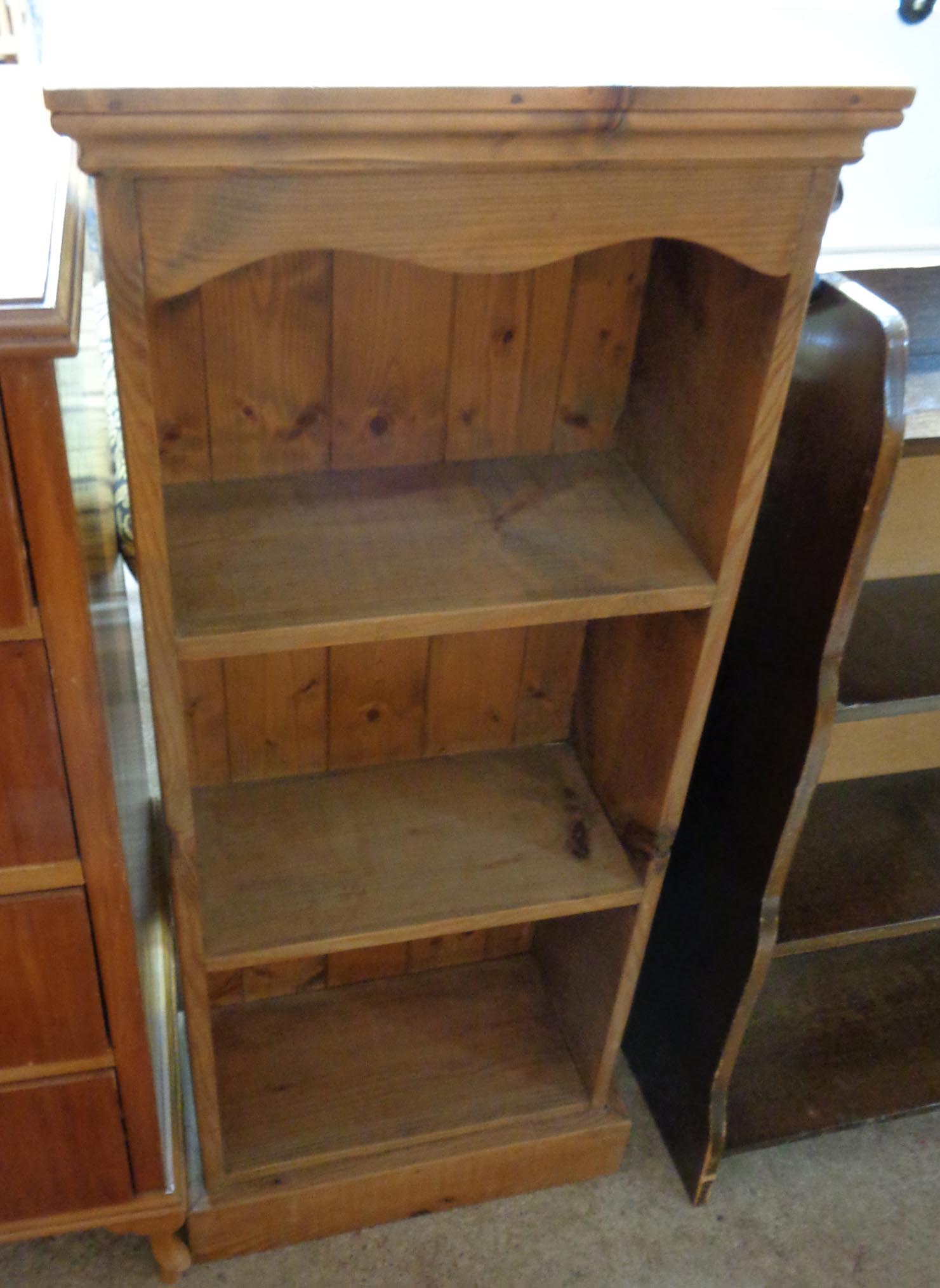 A 17 1/2" waxed pine three shelf open bookcase with plinth base