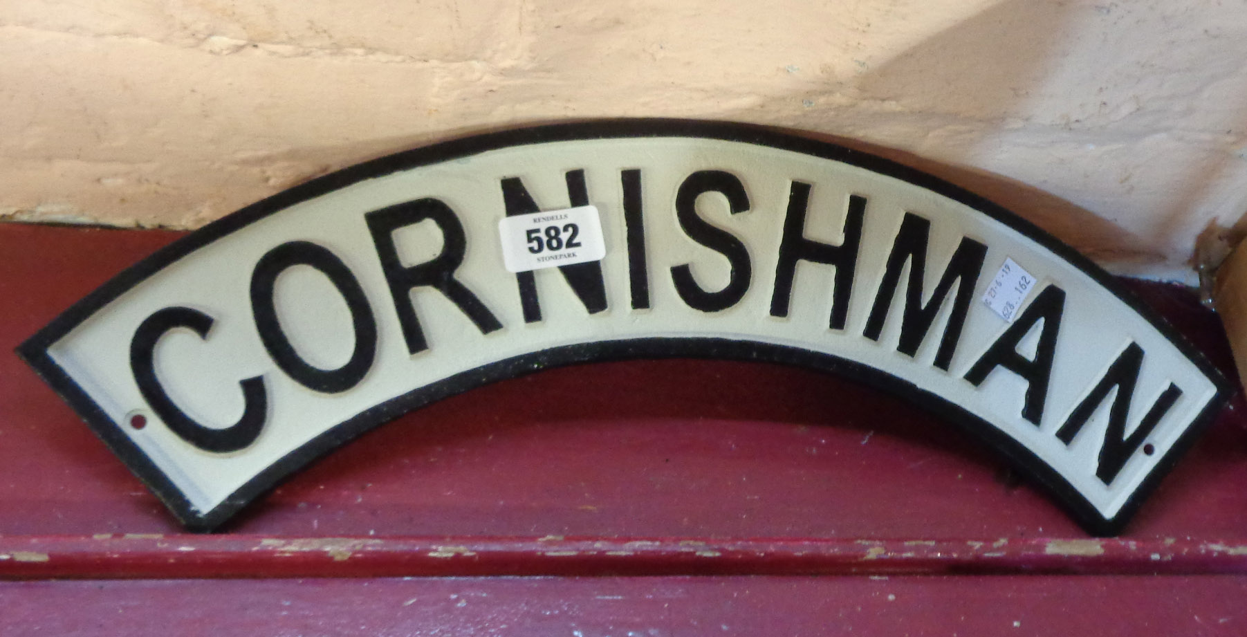 A reproduction painted cast iron Cornishman train sign