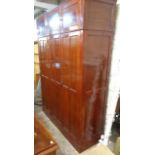 A 5' early 20th Century polished walnut compactum style wardrobe with triple locker cupboard to
