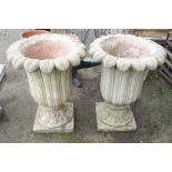 A pair of cast concrete garden urns