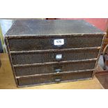 A 15 1/2" vintage East-Light desktop chest of four long drawers with printed snakeskin effect