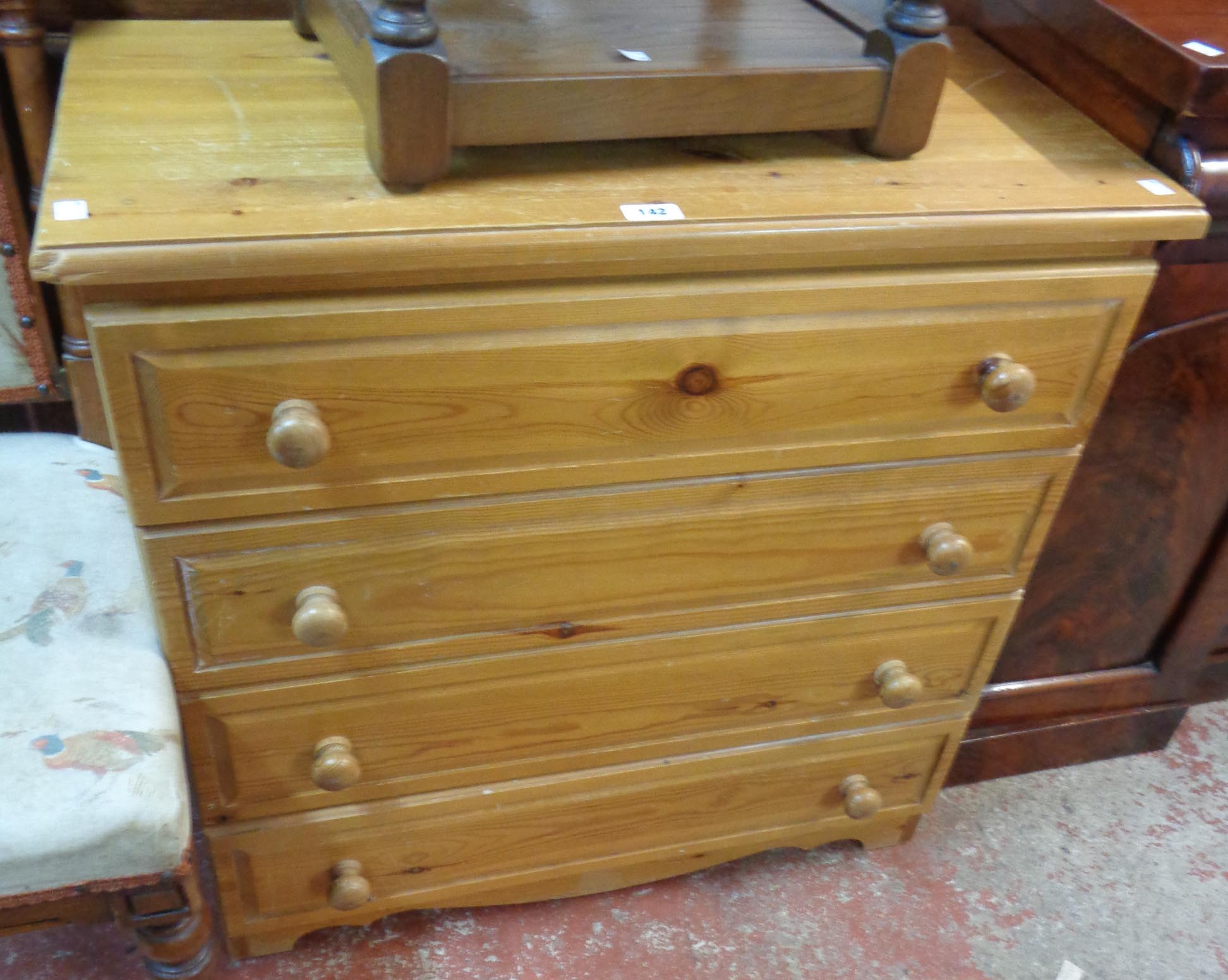 A 32" modern waxed pine chest of four long drawers, set on bracket base