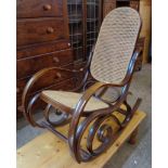 A modern Victorian style bentwood rocking chair with rattan back and seat panels