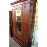 A 4' Victorian mahogany wardrobe with moulded and rounded cornice, hanging space enclosed by a