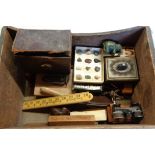 A box containing a quantity of collectable items including folding rules, wax face, cameo, Brownie