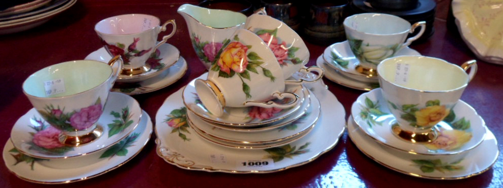 A Paragon part tea set with rose pattern comprising cream jug, sandwich plate and six trios