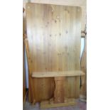 A waxed pine thick sectional topped refectory style dining table set on shaped standard ends and