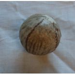 An antique stitched golf ball