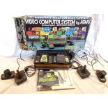 A vintage boxed Atari Model CX-2600 video computer system with controllers, power lead, instructions