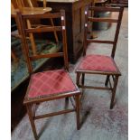 A pair of Edwardian mahogany and strung framed bedroom chairs with studded upholstered seat