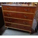 A 3' 4" highly polished mixed wood chest of four long graduated drawers, set on short cabriole legs