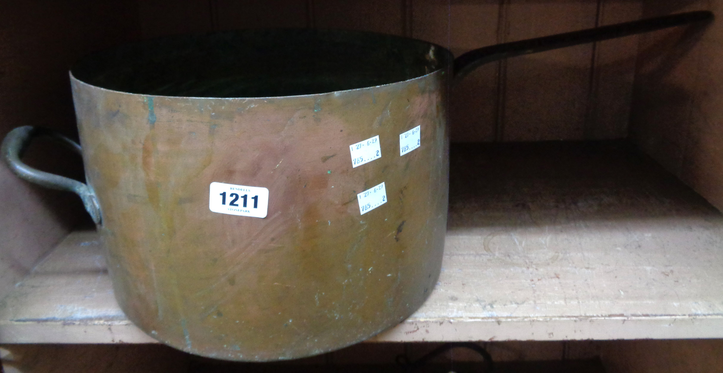 A large antique copper saucepan