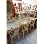 Seven matching 20th Century blonde wood Windsor style kitchen chairs, with solid sectional seats and