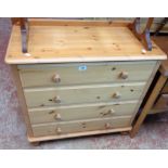 A 33" modern waxed pine chest of four long drawers, set on turned feet