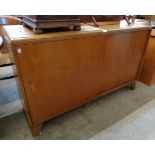 A 4' 6" 1950's Heal and Son. Ltd. mahogany sideboard with cutlery drawer and glass shelves