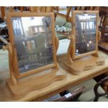 A pair of waxed pine platform dressing table mirrors, set on serpentine bases - various condition