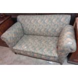 A 4' 9" Edwardian two seater single drop-end settee, set on square tapered front legs with iron