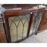 A 3' 11" 1920's mahogany bow front display cabinet with glass shelves and lined interior enclosed by