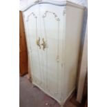 A 36" French style white painted and parcel gilt double wardrobe with hanging space enclosed by a