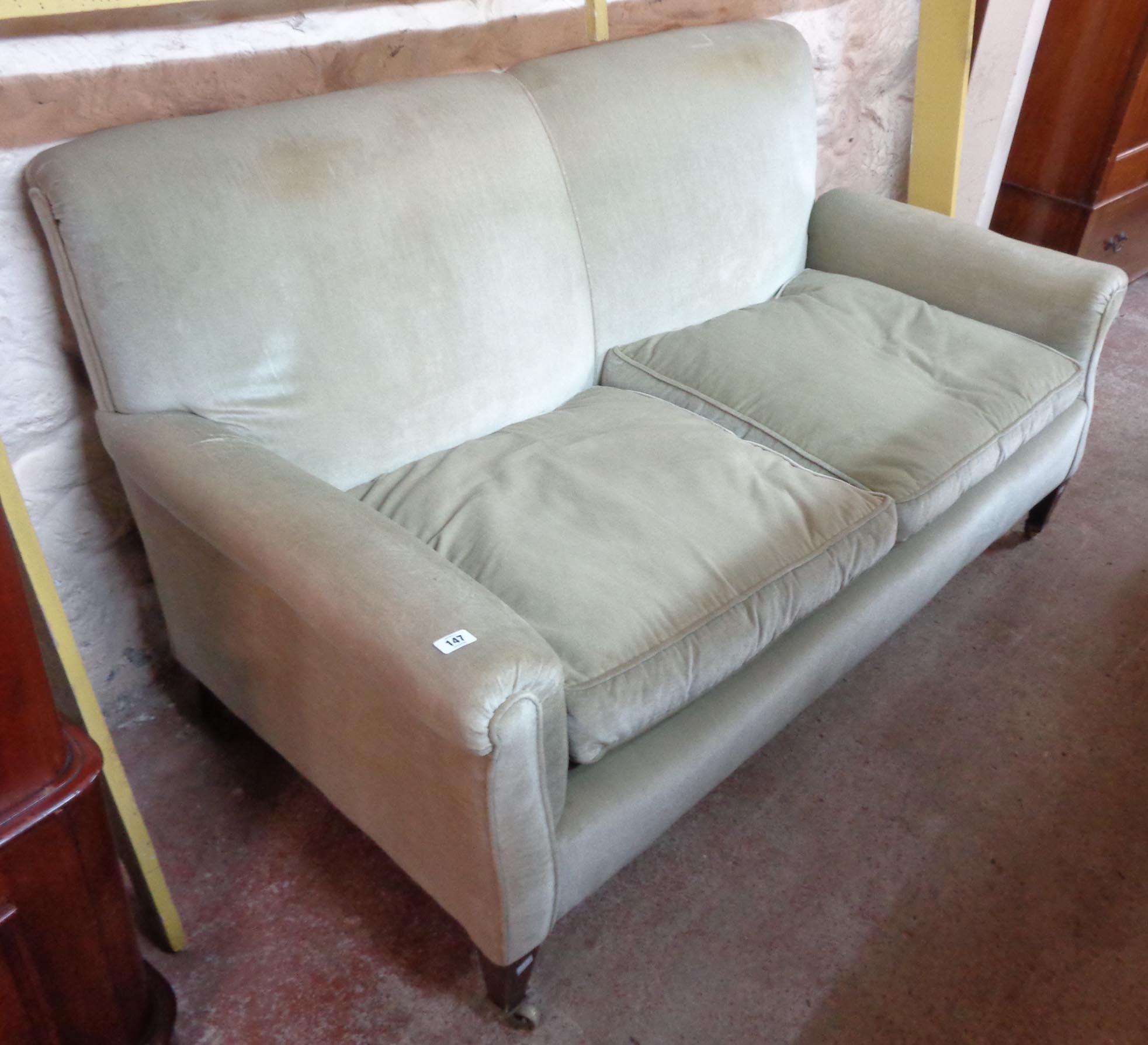 A 5' 4" early 20th Century single drop-end two seater settee upholstered in frosted pale green