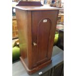 A 15 3/4" late Victorian mahogany pot cupboard with panelled door and flanking reeded decoration