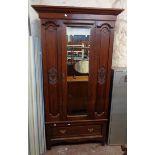 A 3' 5 1/2" Edwardian walnut wardrobe with moulded cornice and hanging space enclosed by a