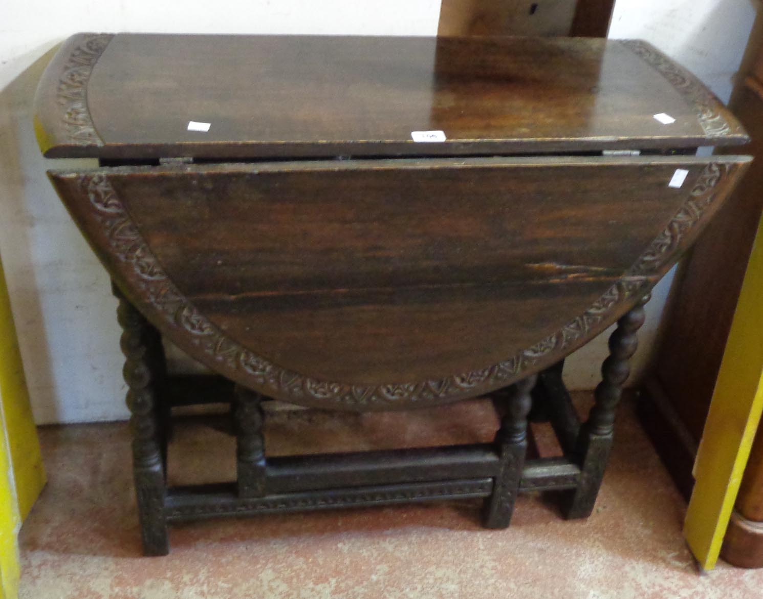 A 36" oak gateleg table with moulded decoration and bobbin turned supports