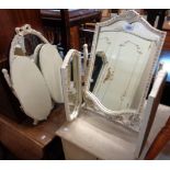 An ornate French style white painted and parcel gilt triple dressing table mirror - sold with