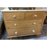 A 36" waxed pine chest of two short and two long drawers, set on turned feet