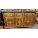 A 4' 7" modern Eastern hardwood sideboard with decorative stone inlay to top and front, three frieze