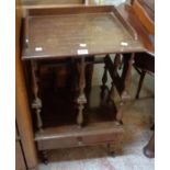 A 19 1/2" Edwardian stained pine Canterbury with turned divider supports and drawer under, set on
