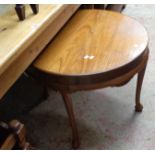 A 30 1/2" diameter polished wood occasional table with moulded apron and legs with pad feet