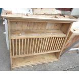 A pine wall mounted plate rack