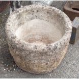 A cast concrete circular planter